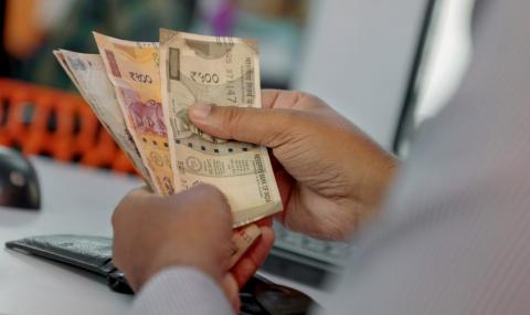 Man holding Indian rupees