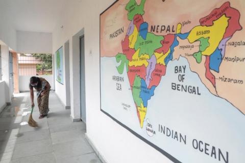 Woman sweeping inside school during covid-19