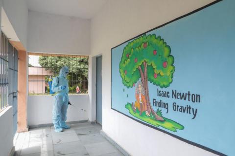 Man sanitizing inside the school during covid-19