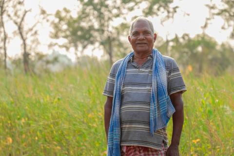 Old man standing in field